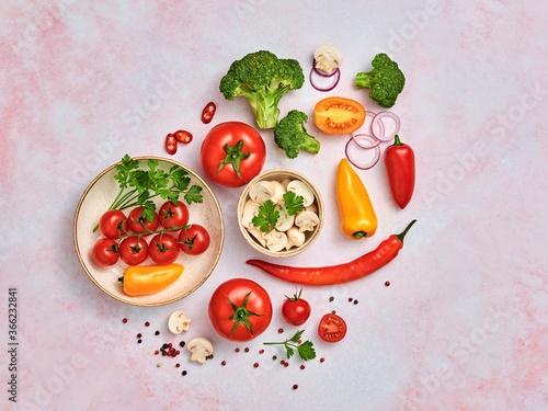 Tomato, spices, bell chili pepper, onion. Vegan diet food, creative composition on marble. Cherry tomatoes, bell pepper, broccoli, champignons layout, cooking colorful concept, top view.