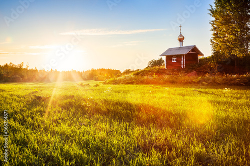 Summer landscape with field and orthodox church