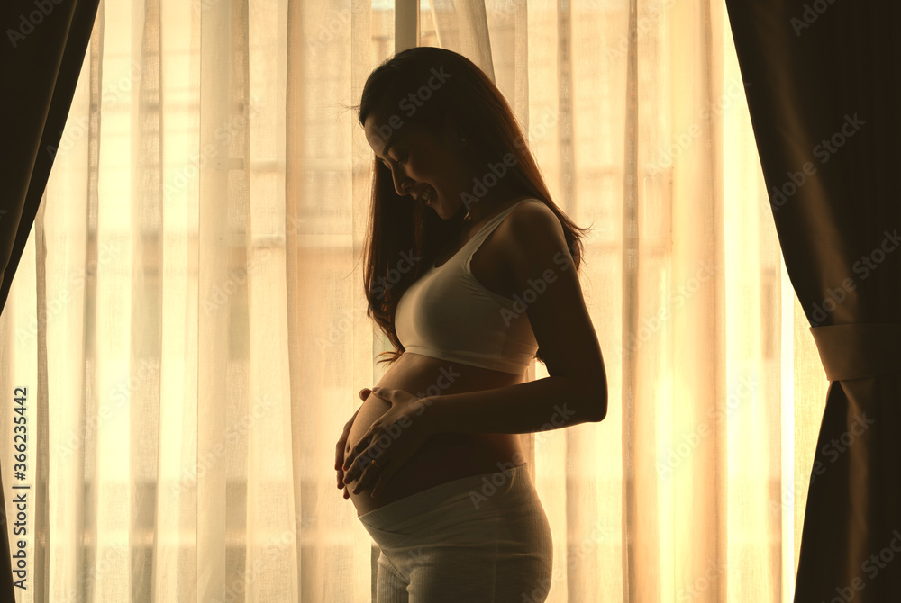 close up pregnant woman in a White underwear, posing Belly of a pregnant woman. smile happy Posing side view standing beside curtain in bedroom her