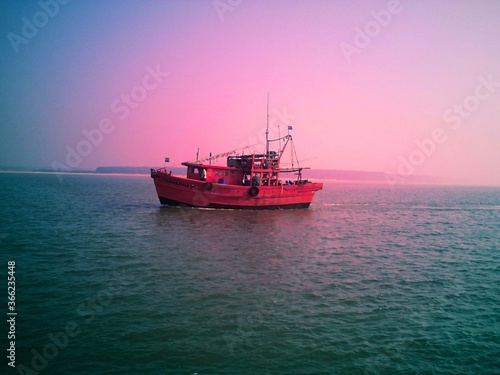 A Fishing trawler in the blue sea at dawn