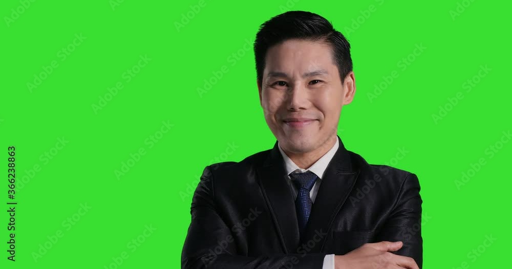 Portrait of asian businessman looking to camera with smile at green screen background. Chroma key green screen background. Portrait of asian businessman looking to camera with smile at green screen background. Chroma key green screen background.