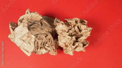 Crumpled brown paper.It is mauled on red background.