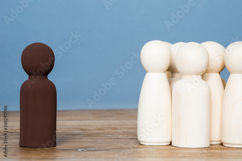A black person segregated from a group of white people in a racial segregation or ethnic minority concept