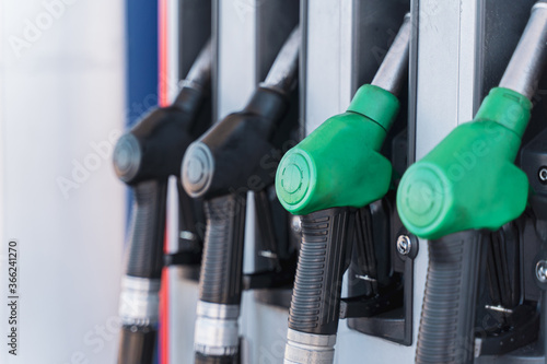 Gasoline and diesel distributor at the gas station. Gas pump nozzles. Petrol filling gun close-up at the gazoline station.