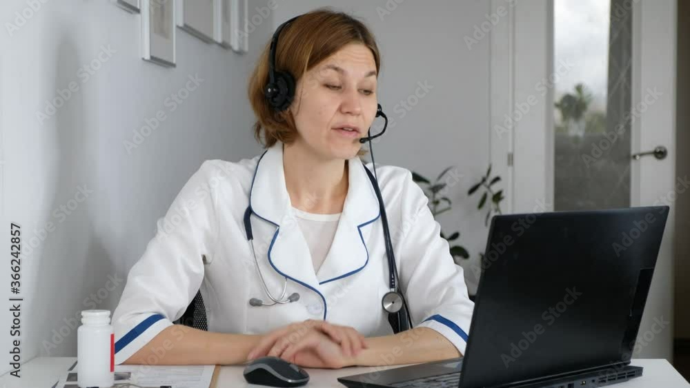 Woman doctor wear uniform with stethoscope talk by conference video call, consult patient online, distant medical consultation in internet Woman doctor wear uniform with stethoscope talk by conference video call, consult patient online, distant medical consultation in internet