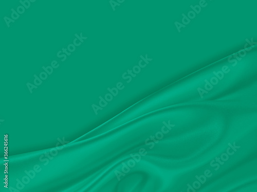 Beautiful elegant wavy emerald green satin silk luxury cloth fabric texture with monochrome green background design. Card or banner.