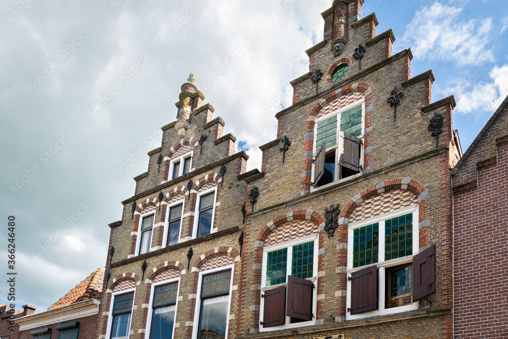 Detailed view of classic dutch canal houses with traditional blinds or shutters in the historic town of Oudewater, Holland