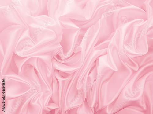 Beautiful elegant wavy light pink satin silk luxury cloth fabric texture, abstract background design. Copy space