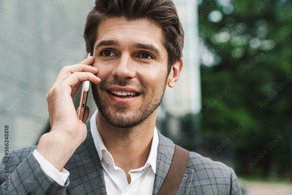 Cheerful business man outdoors talking by mobile phone Cheerful business man outdoors talking by mobile phone