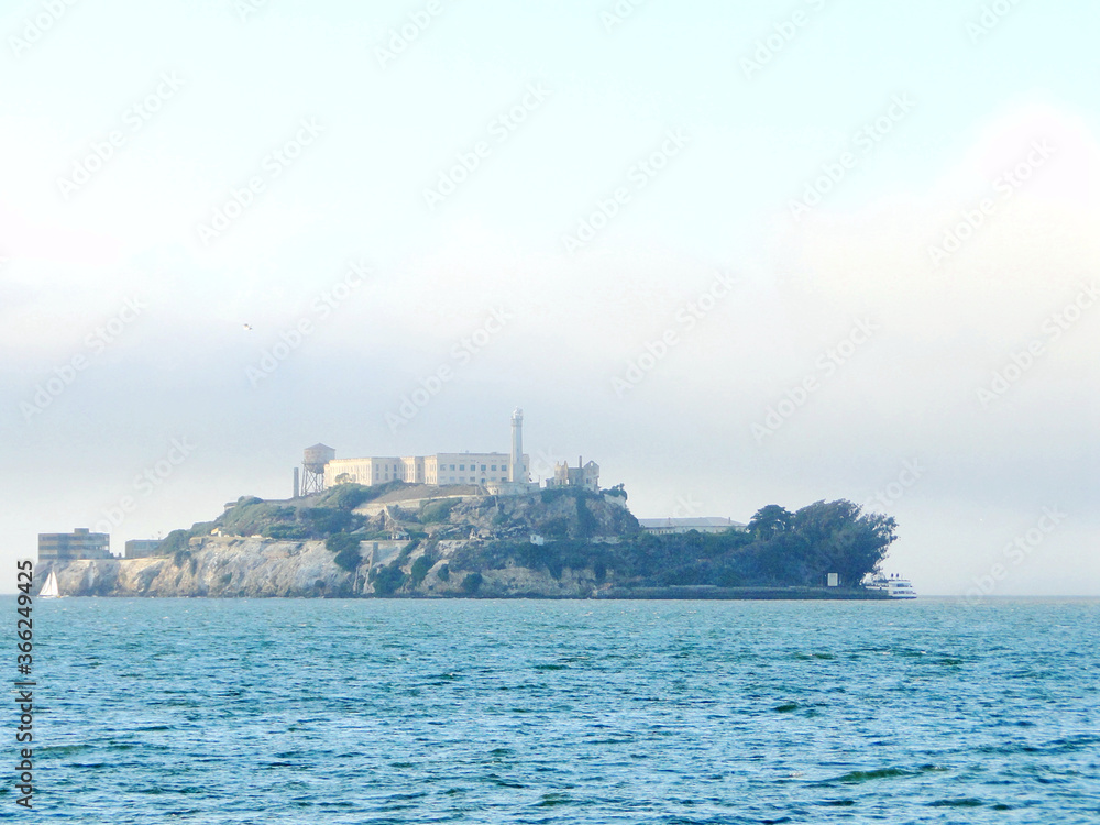 Landscape of Alcatraz Island in San Francisco bay on a fogy day. This island was a formal lighthouse, military fortification, military prison, and federal prison.