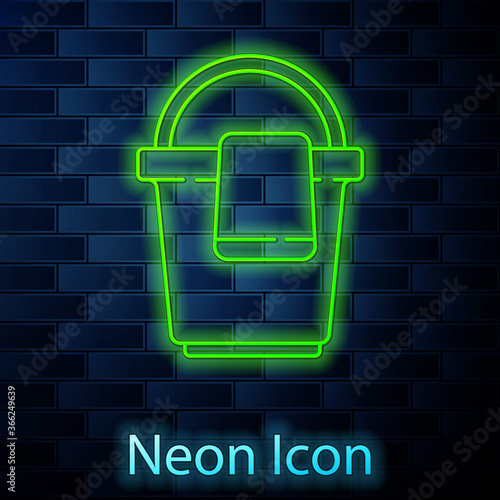 Glowing neon line Bucket with rag icon isolated on brick wall background. Cleaning service concept. Vector Illustration.