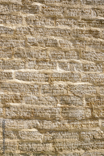 stone wall of roughly cut limestone blocks of different sizes as a background