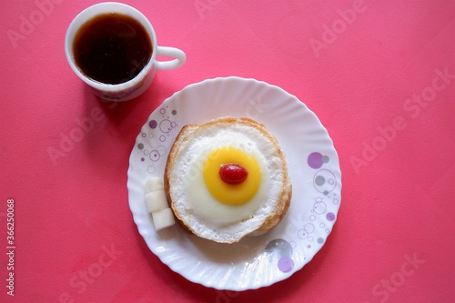 Homemade Fried Egg on burger and cup of Coffee for Breakfast,cherry top view, 