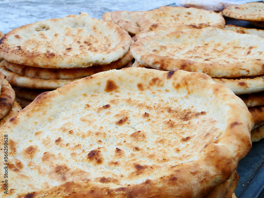 Naan in Turpan,?Xinjiang,?China, leavened and oven-baked?flatbread, it is merely the generic word for any kind of bread, ?It can be used to scoop other foods or served stuffed with a filling. Naan in Turpan,?Xinjiang,?China, leavened and oven-baked?flatbread, it is merely the generic word for any kind of bread, ?It can be used to scoop other foods or served stuffed with a filling.