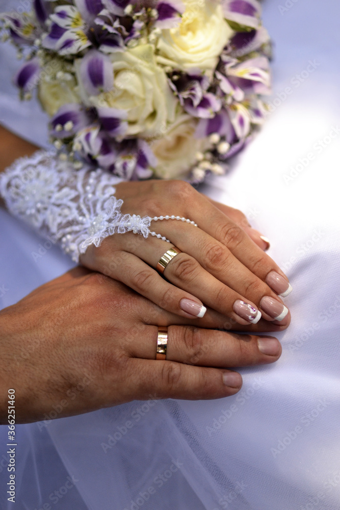 gold rings on the fingers of the newlyweds gold rings on the fingers of the newlyweds