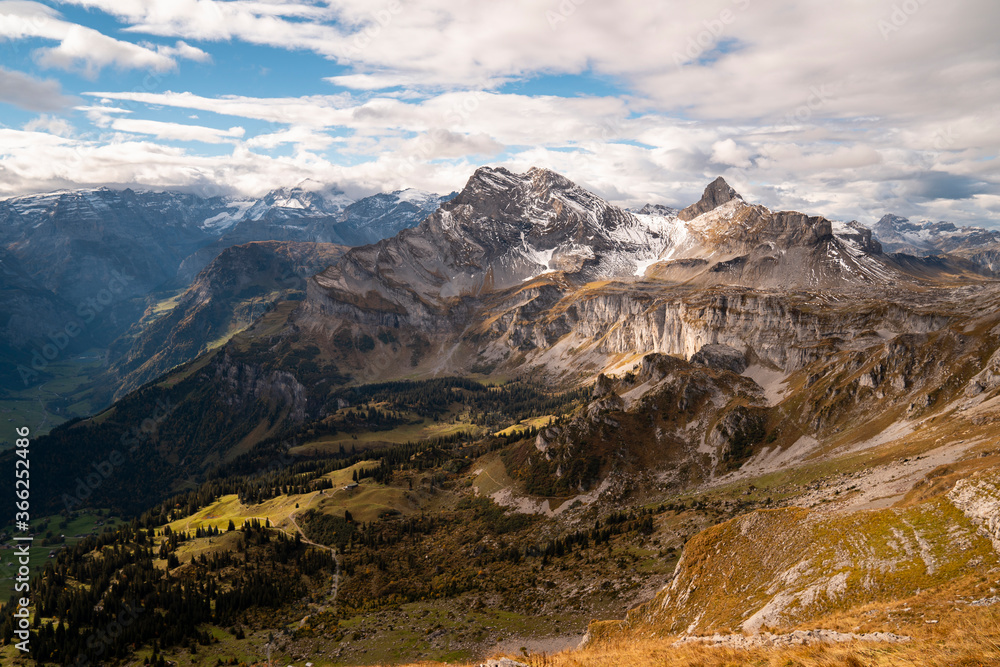 Beautiful snowy mountains in Switzerland during late summer hiking