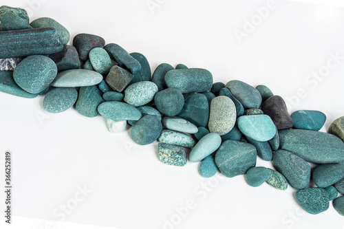 Canvas Print turquoise sea stones in a row on a white background