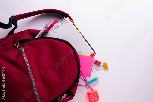 school dark red backpack and stationary items