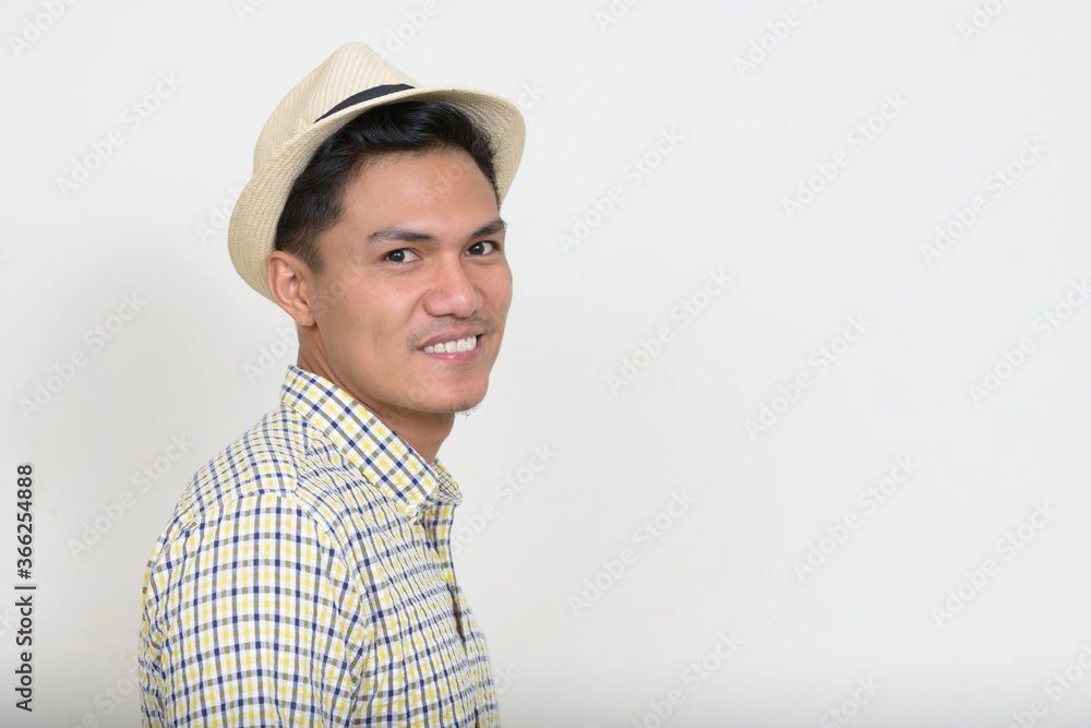 Portrait of happy handsome Asian tourist man smiling Portrait of happy handsome Asian tourist man smiling
