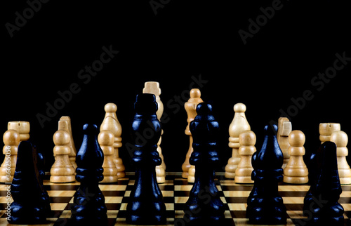 Black and White Chess Pieces on a Wooden Chess Board