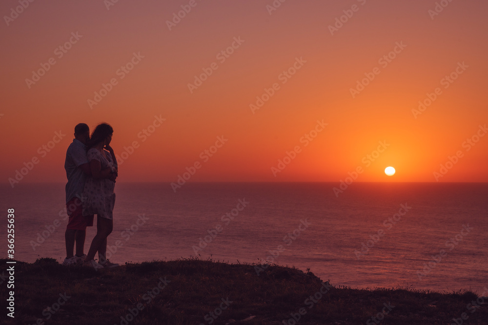 The couple against the beautiful sunset