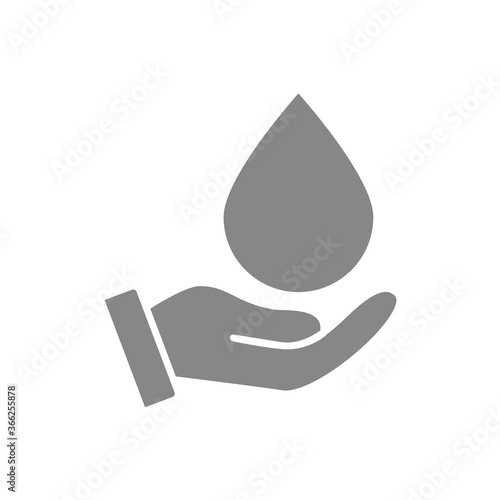 Water drop on hand grey icon. Cleaning supply, hand disinfection symbol