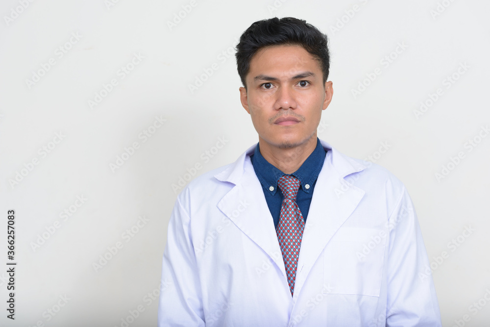 Portrait of handsome Asian man doctor looking at camera Portrait of handsome Asian man doctor looking at camera