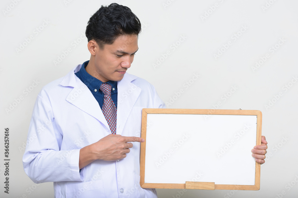 Portrait of handsome Asian man doctor holding white board Portrait of handsome Asian man doctor holding white board