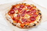 Pepperoni pizza on a white wooden table background
