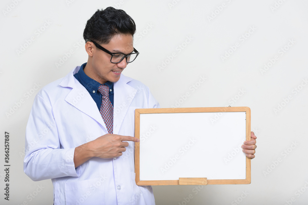 Portrait of handsome Asian man doctor holding white board Portrait of handsome Asian man doctor holding white board