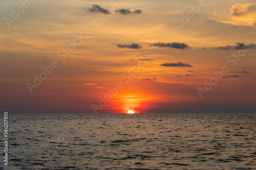 Sunset on the island of Phu Quoc, Vietnam. Travel and nature concept. Evening sky, clouds, sun and sea water