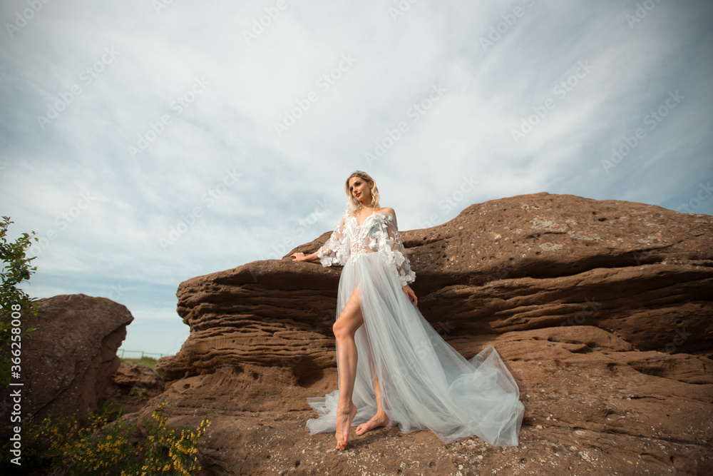 beautiful young female with makeup and hairstyle in a gentle wedding negligee
