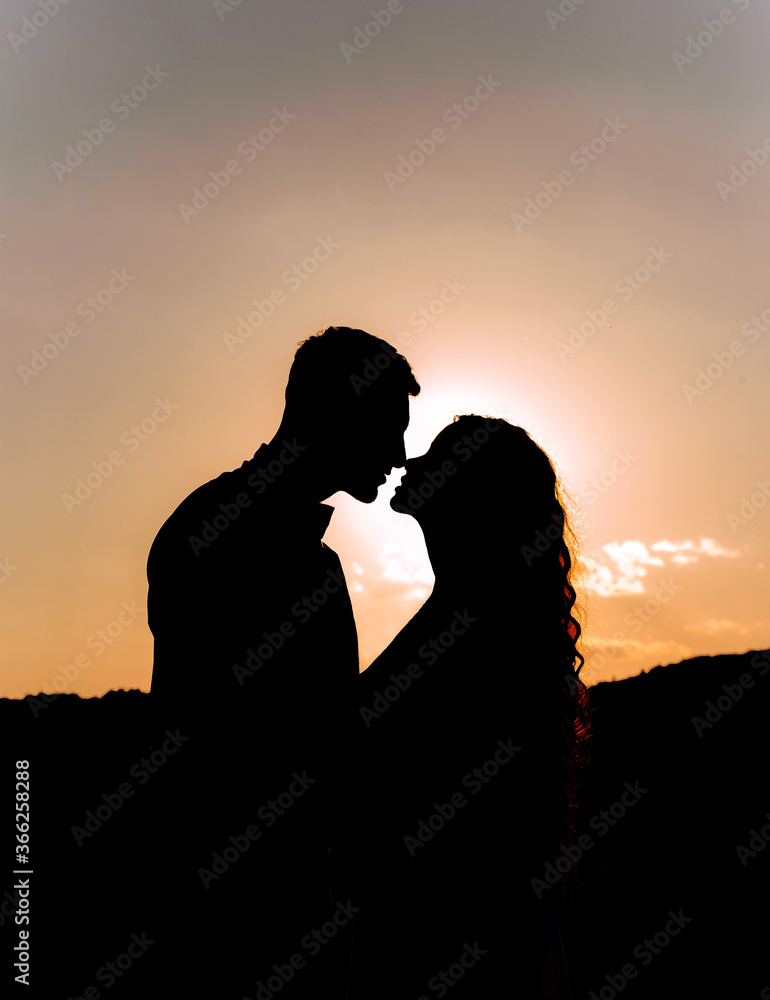 Beautiful silhouette of a couple in love at sunset.