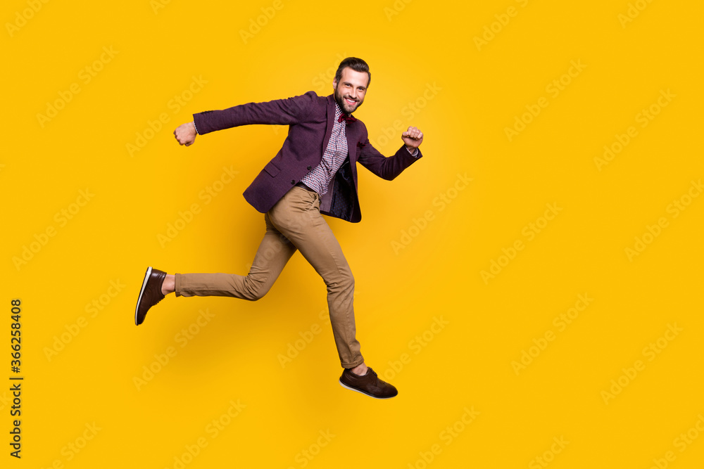 Full size profile photo of handsome stylish well-dressed business guy jump high up rushing store mall sales season wear plaid shirt blazer trousers shoes isolated yellow color background