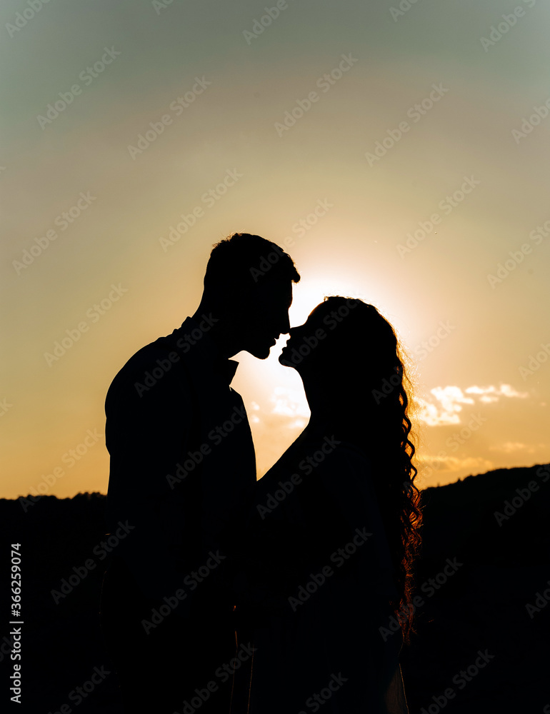 Lovely silhouette of a couple in love at sunset.