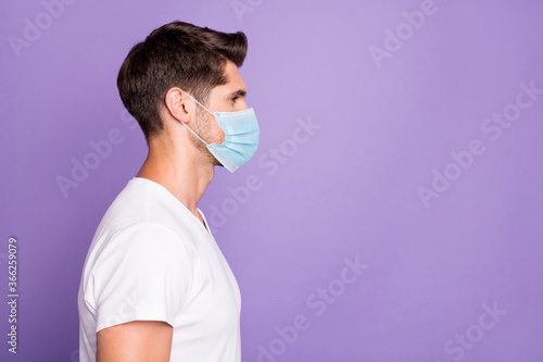 Profile side view portrait of his he nice attractive healthy guy freelancer modern haircut copy space wearing safety mask isolated bright vivid shine vibrant lilac violet purple color background