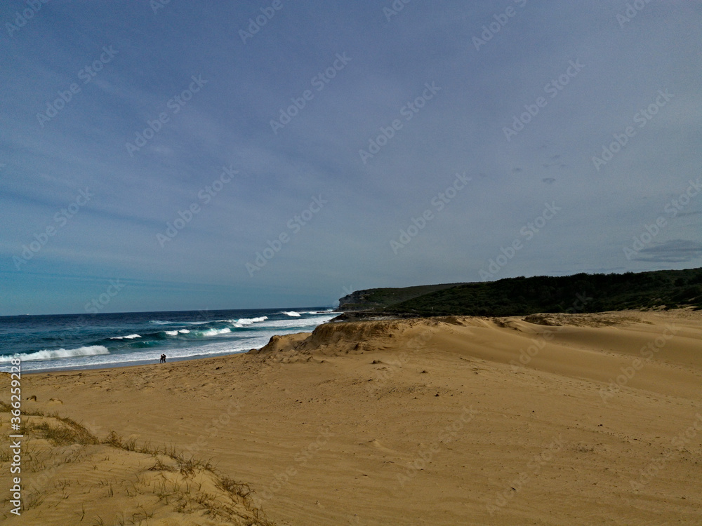 Beautiful view of a sandy beach with ocean wave and sand dune, Marley Beach, Royal National Park, Sydney, Australia Beautiful view of a sandy beach with ocean wave and sand dune, Marley Beach, Royal National Park, Sydney, Australia