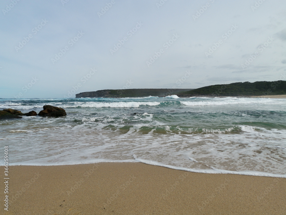 Beautiful view of a sandy beach with ocean wave, Marley Beach, Royal National Park, Sydney, Australia