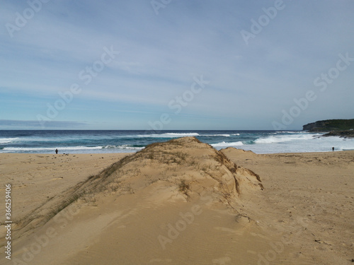 Beautiful view of a sandy beach with ocean wave and large sand dune, Marley Beach, Royal National Park, Sydney, Australia