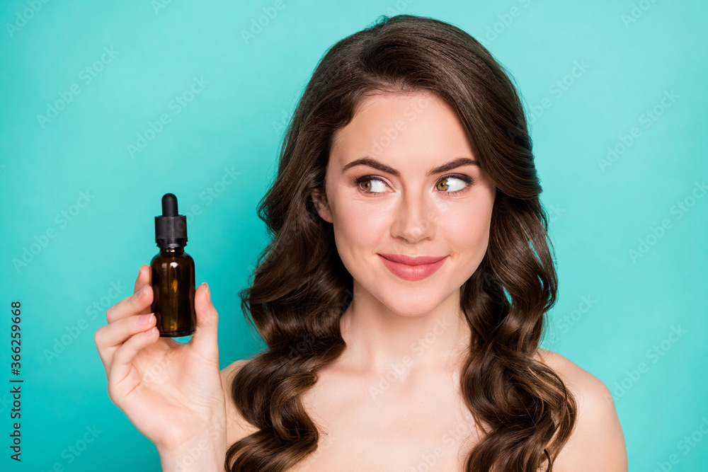 Closeup photo of beautiful naked lady wavy long hairdo hold professional cure serum bottle oil treatment cosmetologist specialist advising buy product isolated teal color background Closeup photo of beautiful naked lady wavy long hairdo hold professional cure serum bottle oil treatment cosmetologist specialist advising buy product isolated teal color background