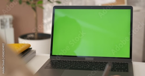 Wallpaper Mural Online education. Girl looking at green screen laptop computer in living room watching movie, video content. Over shoulder close up view. Business woman or female freelancer working from home office Torontodigital.ca