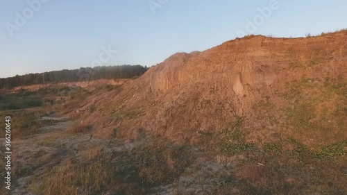Autumn landscape in the mountains. An abandoned sand pit. Aerial video