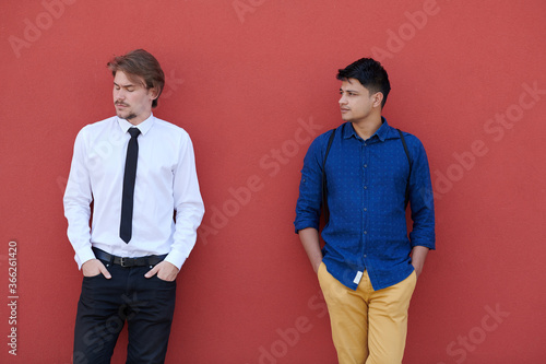 portrait of multiethnic startup business men in front of pink wall