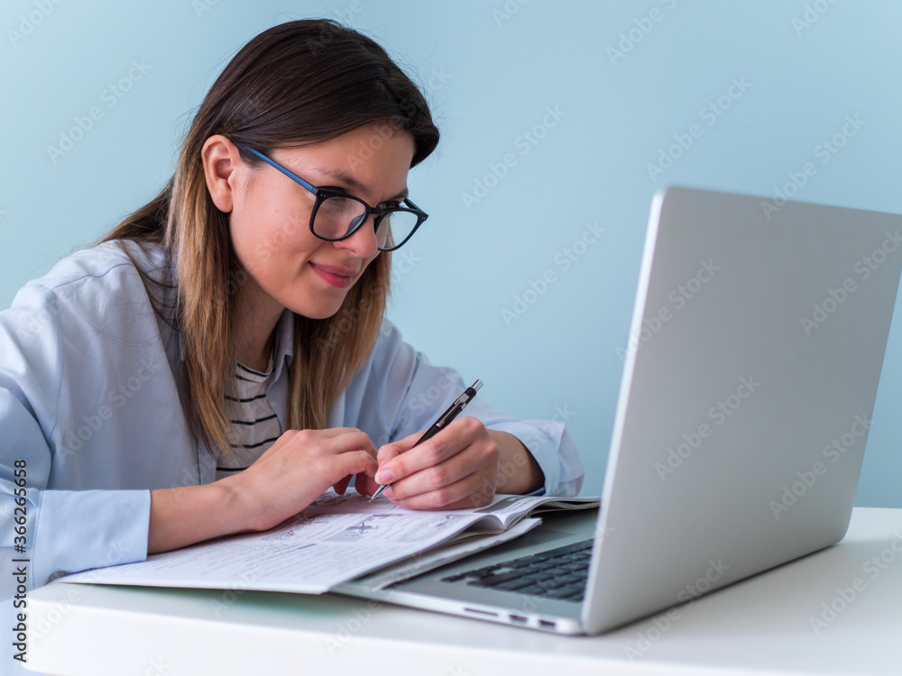 Distance learning online education. Woman studying with laptop, watching webinar Distance learning online education. Woman studying with laptop, watching webinar