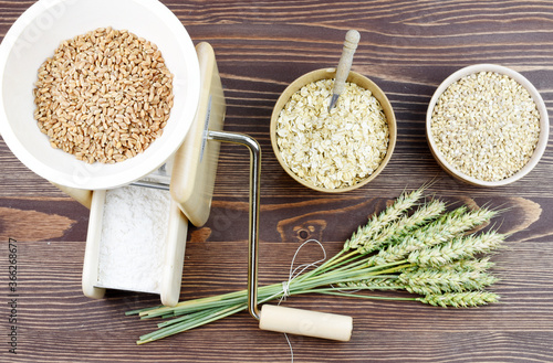 A small grain grinder on a wooden background. Traditional wheat and grain grinder used to grind grain and make flour of wheat and rice. Czech Republic, Europe. photo