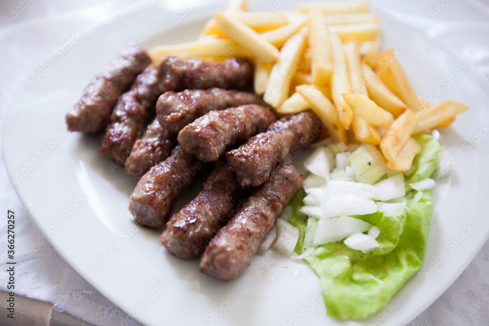 Traditional grilled meat kebab with french fries