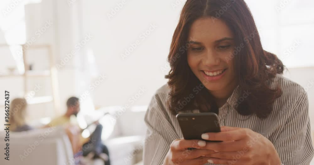 Beautiful woman smiling while using smart phone Beautiful woman smiling while using smart phone