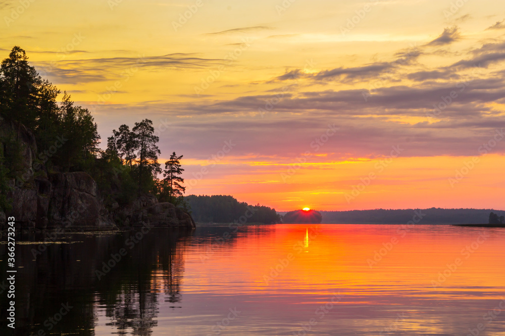 Fototapeta premium Sunset sun over Vyborg Bay in summer