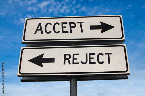 Accept vs reject. White two street signs with arrow on metal pole with word. Directional road. Crossroads Road Sign, Two Arrow. Blue sky background. Two way road sign with text.