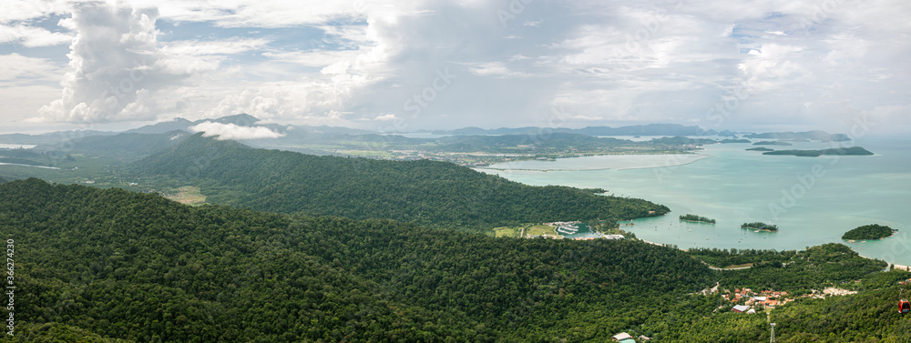 Fototapeta premium Landscape Panorama over the Island of Langkawi, Malaysia At the sky bridge in the north of Langkawi, Malaysia. Panorama landscape on a cloudy day over the shore of the small malaysian island